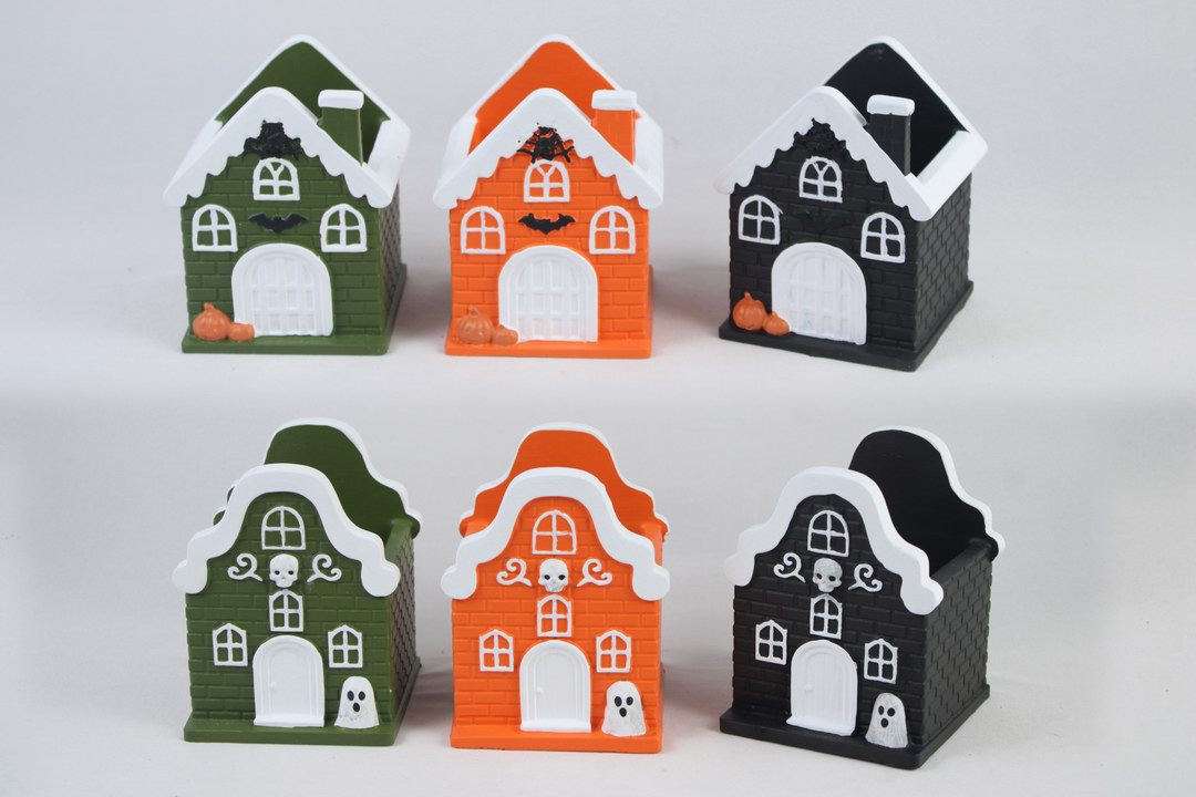 Green, orange and black Halloween house-shaped cement planters.