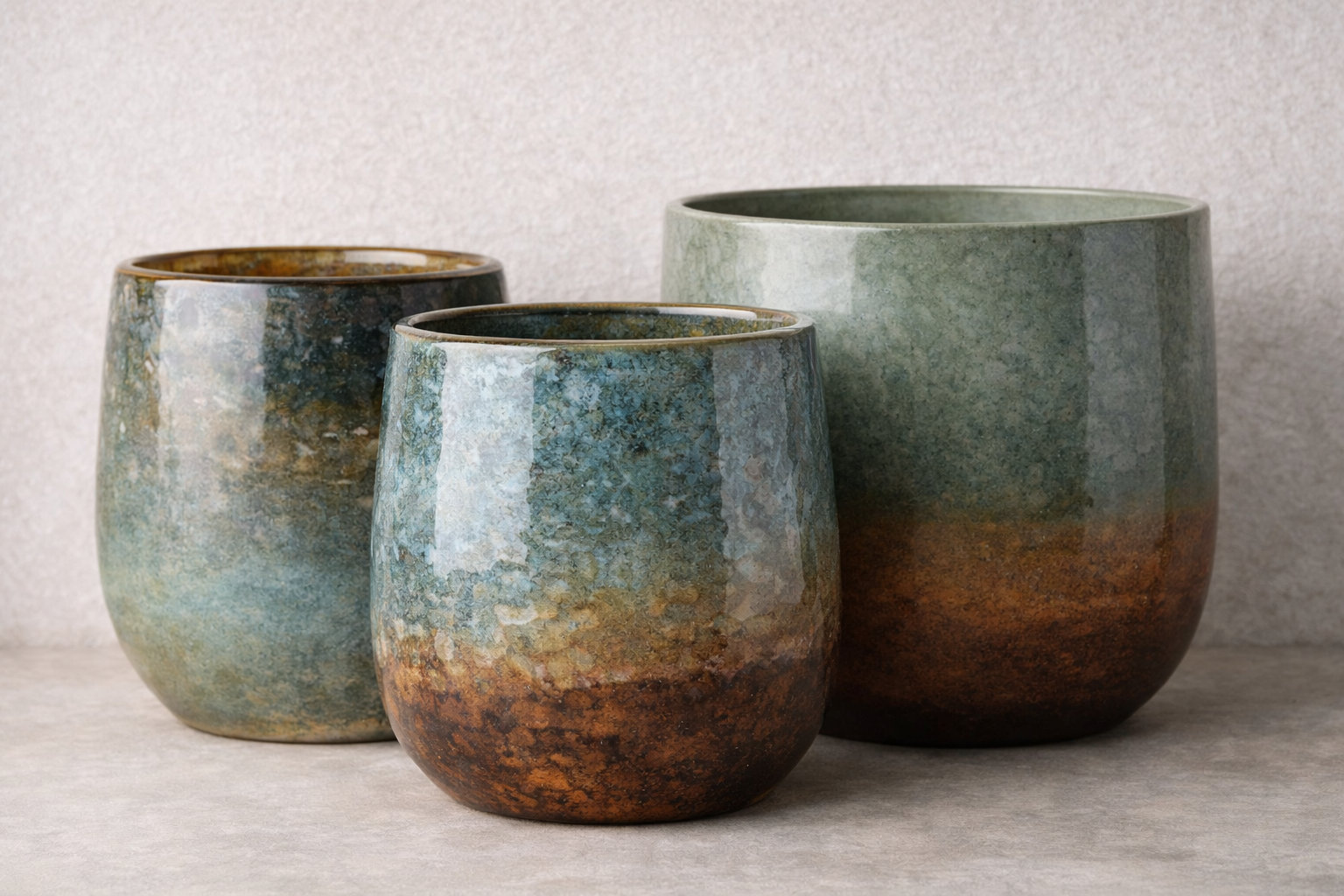 Reactive-glaze ceramic planter samples showing color movement and variation between fired pieces