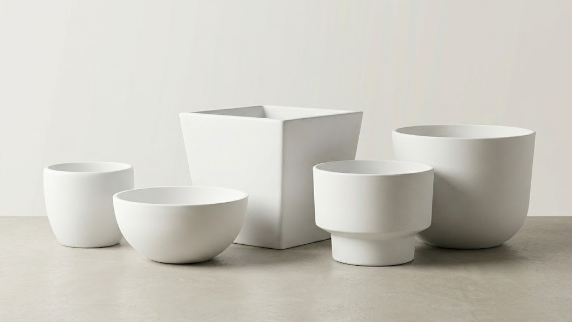 Resin and composite planter samples in different shapes and finishes with close-up surface details